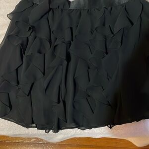 Black ruffle mini skirt.
